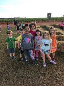 kids posing near hay bales
